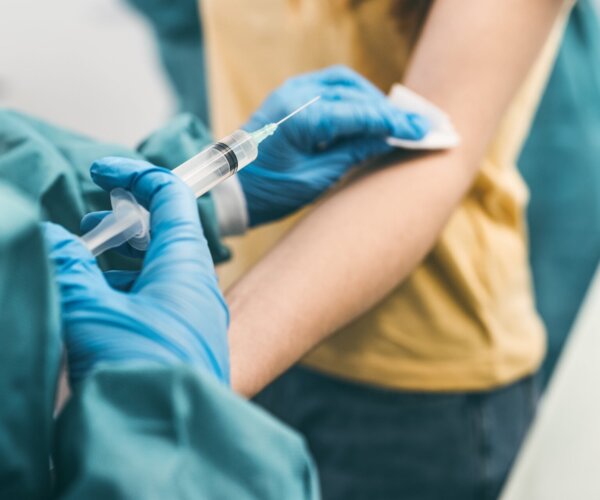 Close up woman doctor doing syringe vaccine in hospital for preventing a stop corona virus outbreak - Healthcare medicine and medical cure against pandemic concept