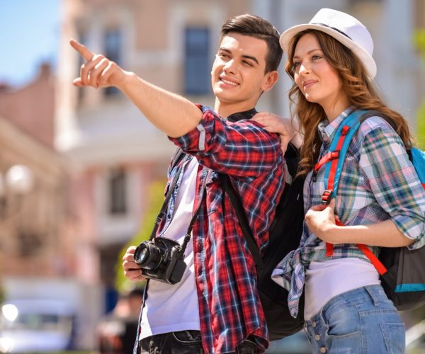 Young attractive couple walking in old european city.